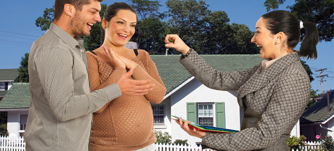 Couple being handed house keys by real estate agent for their new home.