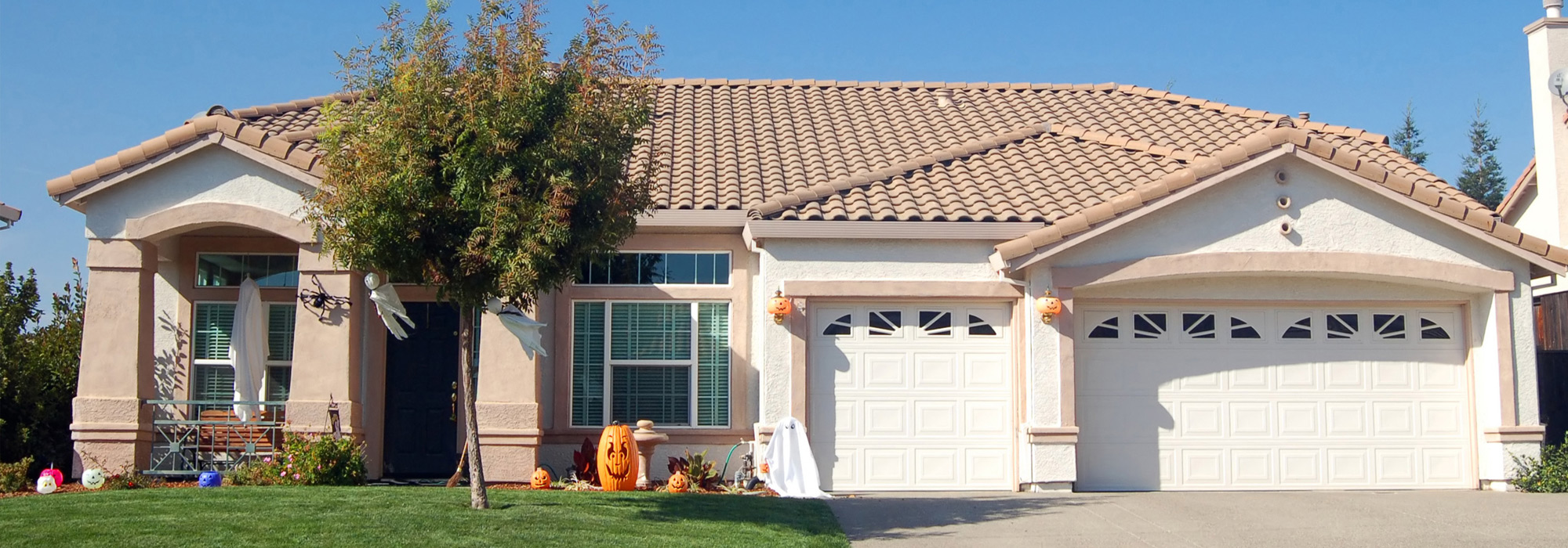 Single-family home with holloween decorations in front yard.